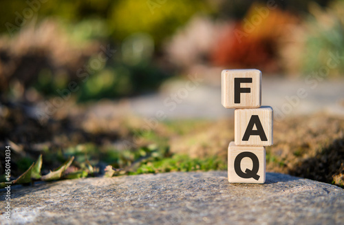 FAQ text on cubes standing on a stone on a natural background