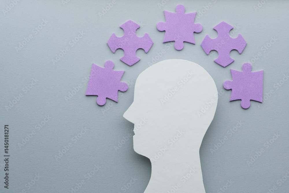 Creative concept of Alzheimer's disease silhouette of head with purple puzzles on gray background. Mental health problems and memory challenges. Creative concept of Alzheimer's disease silhouette of head with purple puzzles on gray background. Mental health problems and memory challenges.