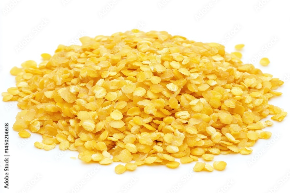 Close-up of a vibrant pile of yellow seeds on a white background, showcasing their texture and color Close-up of a vibrant pile of yellow seeds on a white background, showcasing their texture and color