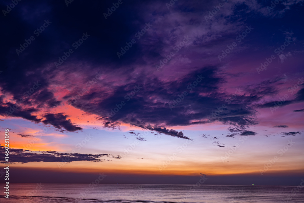 Fototapeta premium Aerial view sunset sky,Nature beautiful light sunset or sunrise over sea surface,Colorful sunset sky with clouds and waves in the ocean,Wide angle sea background
