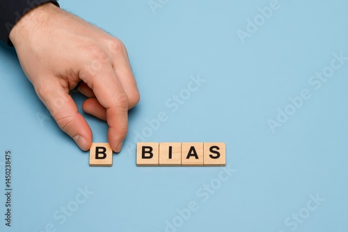 Hand Arranging Wooden Blocks Spelling Bias Concept Image Social Issues Psychology Unconscious Prejudice Cognitive Bias Decision Making Fairness Equality Justice Subjectivity Objectivity Perspective   