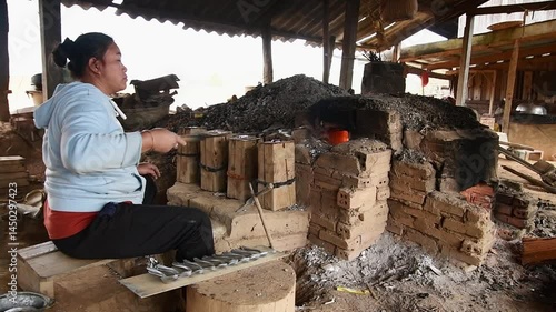 Ban Napia, Laos - 15th january, 2024: laotian people make aluminum spoons from Vietnam war era munition remains or UXO. Collect UXO , melt down in kiln and fashion it to spoons household items