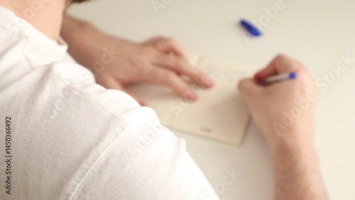 A man uses a technique called morning pages to spew excess thoughts onto paper