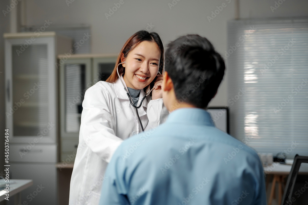 Fototapeta premium Friendly female doctor using stethoscope examining heartbeat of male patient during medical consultation in hospital clinic