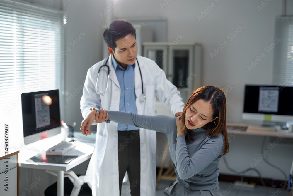 Obraz premium Doctor examining shoulder of young woman experiencing pain during medical consultation in clinic