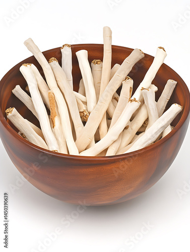 Obraz na płótnie A wooden bowl overflowing with light-colored stick-like textured treats with brown ends. w salonie