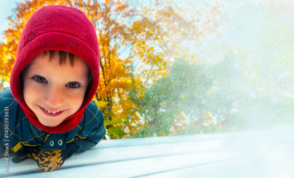 Close-up portrait of happy child girl in autumn park. Smiling little child girl in the autumn park.
