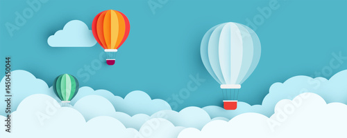 Creative paper cut design featuring colorful hot air balloons floating in the sky with fluffy clouds