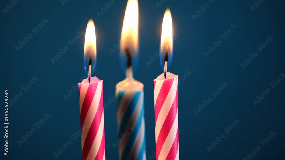 Three Lit Birthday Candles Against a Dark Blue Background Three Lit Birthday Candles Against a Dark Blue Background