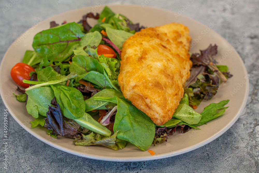 Breaded fish Haddock on a salad ready to eat Breaded fish Haddock on a salad ready to eat