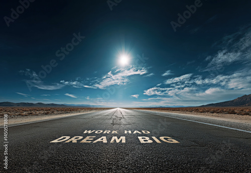Obraz na płótnie A vast road stretches into the horizon with inspirational words painted on it, reminding viewers to dream big and stay dedicated on their journey to achieving their goals. w salonie