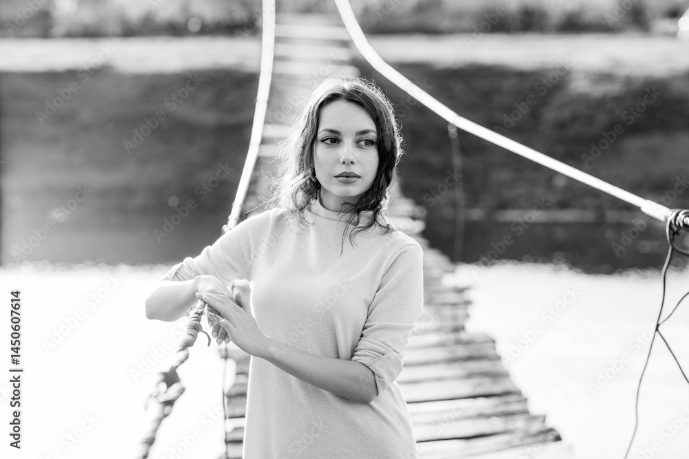 beautiful brunette european girl in blue trench coat at nature. Young lady with beautiful face and lips.