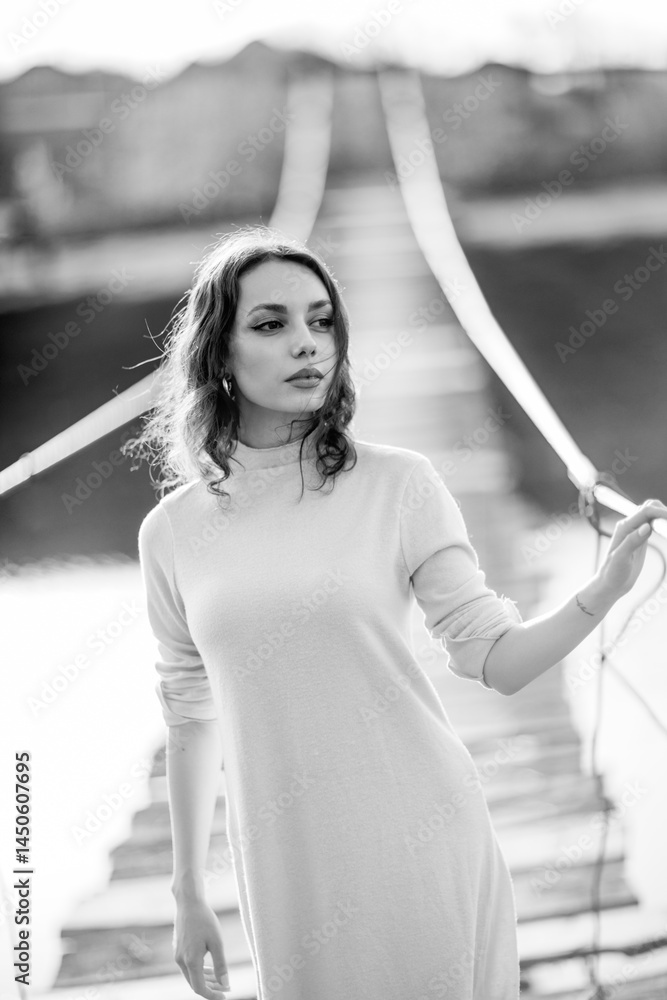 beautiful brunette european girl in blue trench coat at nature. Young lady with beautiful face and lips.