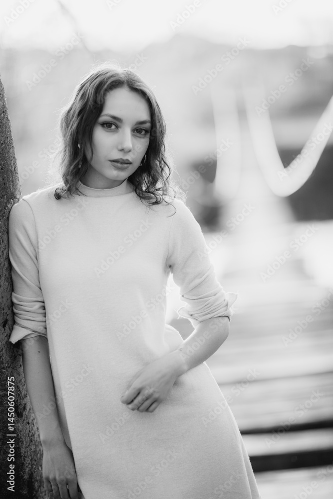 beautiful brunette european girl in blue trench coat at nature. Young lady with beautiful face and lips.