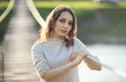 Obraz na płótnie beautiful brunette european girl in blue trench coat at nature. Young lady with beautiful face and lips. w salonie