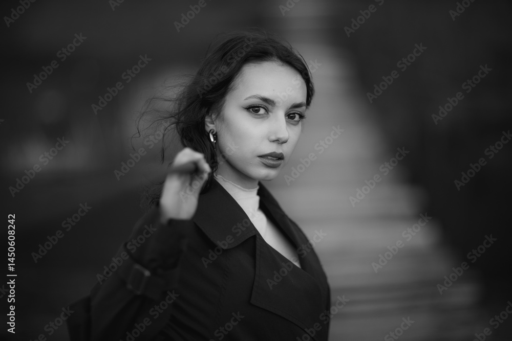 beautiful brunette european girl in blue trench coat at nature. Young lady with beautiful face and lips.