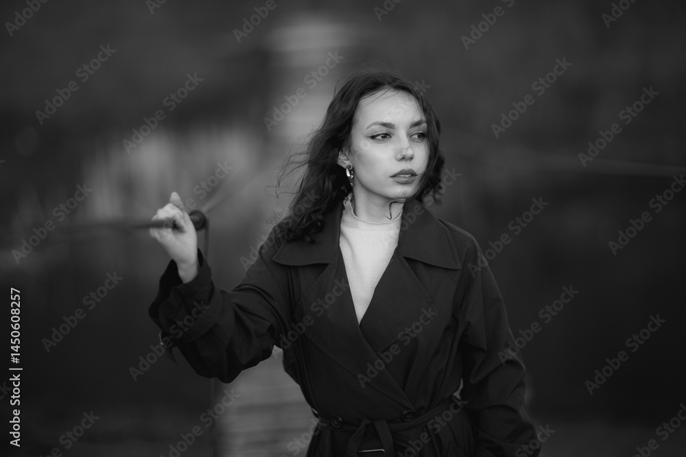 beautiful brunette european girl in blue trench coat at nature. Young lady with beautiful face and lips.