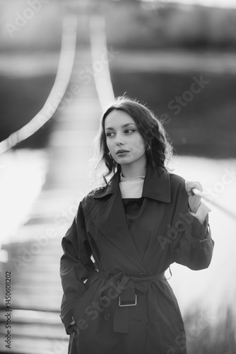 Obraz na płótnie beautiful brunette european girl in blue trench coat at nature. Young lady with beautiful face and lips. w salonie