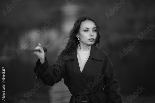 Obraz na płótnie beautiful brunette european girl in blue trench coat at nature. Young lady with beautiful face and lips. w salonie