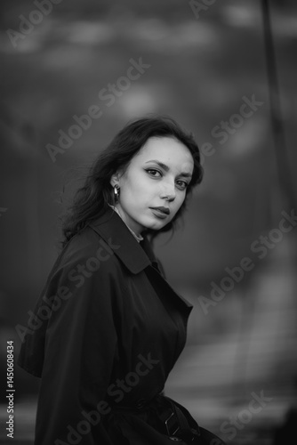 Obraz na płótnie beautiful brunette european girl in blue trench coat at nature. Young lady with beautiful face and lips. w salonie