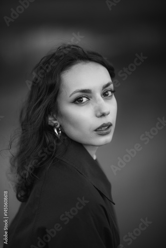 Obraz na płótnie beautiful brunette european girl in blue trench coat at nature. Young lady with beautiful face and lips. w salonie