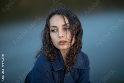 Obraz na płótnie beautiful brunette european girl in blue trench coat at nature. Young lady with beautiful face and lips. w salonie