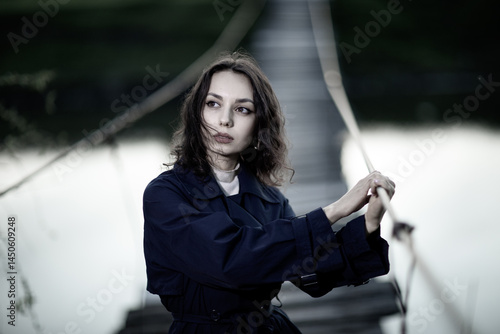 Obraz na płótnie beautiful brunette european girl in blue trench coat at nature. Young lady with beautiful face and lips. w salonie