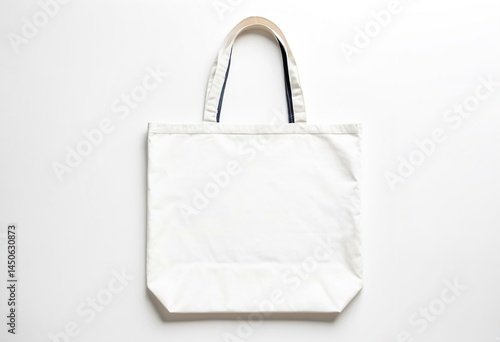 A white tote bag on a white surface.