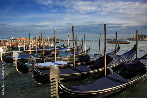 Row of Gondolas Moored in Venice Lagoon. Venice. Italy