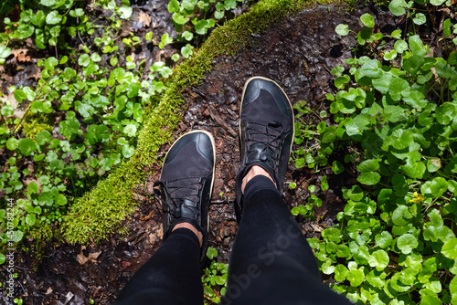 Photos Woman legs with barefoot hiking shoes in the summer mountain