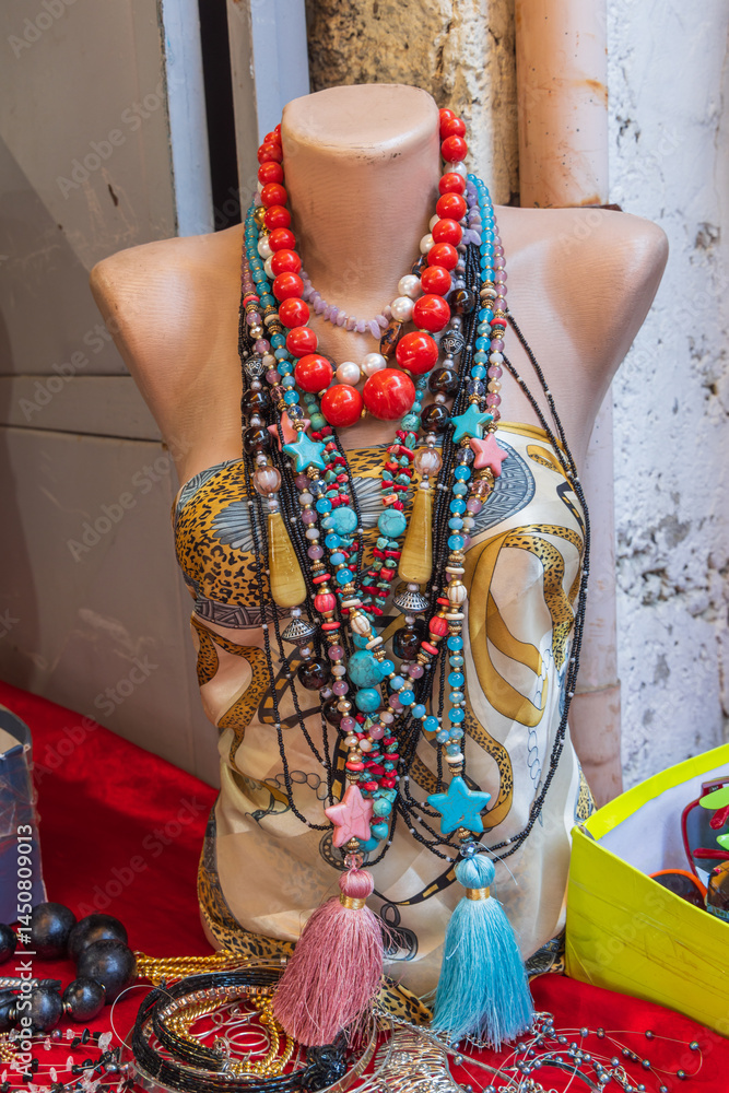 Mannequin with chunky, colorful beaded necklaces.