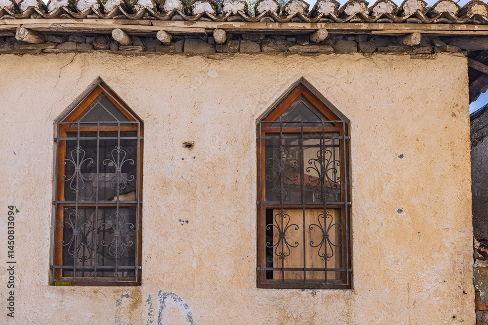 Iron barred windows on an old building in Kruje, Albania.