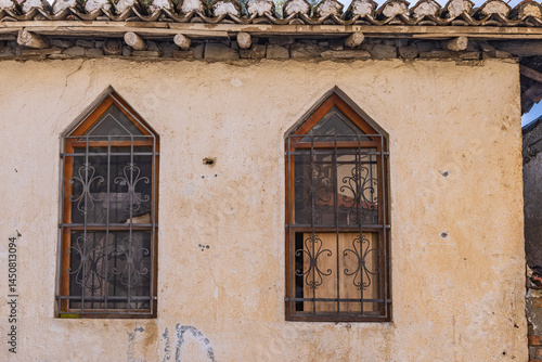 Iron barred windows on an old building in Kruje, Albania.