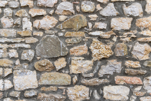 Quadro su tela Patterns on a rough cut stone wall.