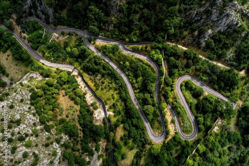 Stunning Aerial Perspective of Serpentine Switchback Roads Winding Through Lush Green Mountains