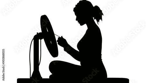 Focused silhouette of woman embroidering at home, artistic expression