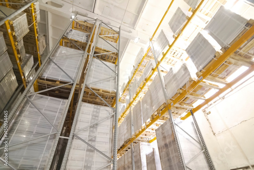 Racks with goods in large warehouse. Storage room.