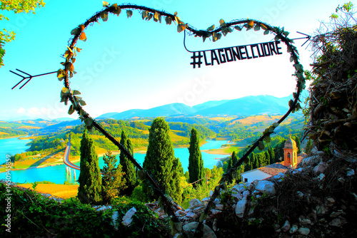 LAGO DI CINGOLI, ITALY - AUGUST 4, 2022: Instagrammable spot. A wired heart with foliage and hashtag, overlooking the lake, a tranquil place in nature where people can take photos and savor the views