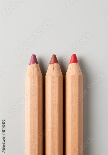 Eco-friendly wooden lip pencils in red, mauve, and brown sustainable cosmetics