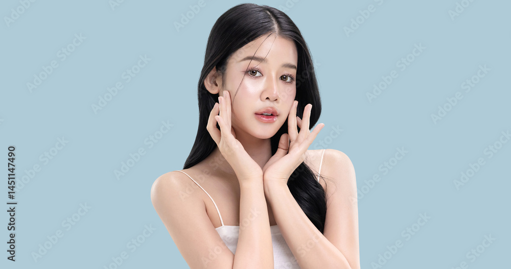 Glowing skin make up style of beautiful young Asian model isolated on blue background. Glowing skin make up style of beautiful young Asian model isolated on blue background.
