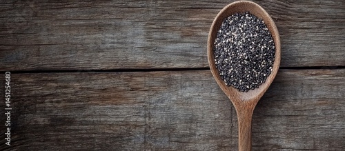 Fototapeta Naklejka Na Ścianę i Meble -  Chia Seeds in a Wooden Spoon on Weathered Wood Surface with Rustic Charm