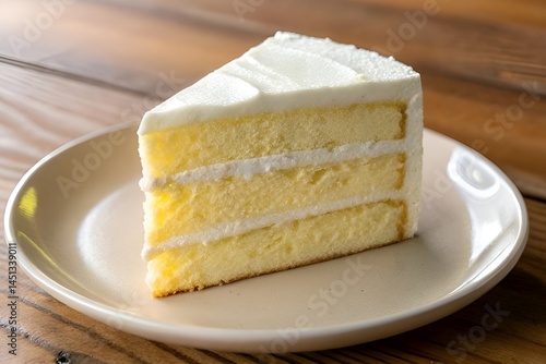 Fluffy Yellow Layer Cake Slice on White Plate with Frosting