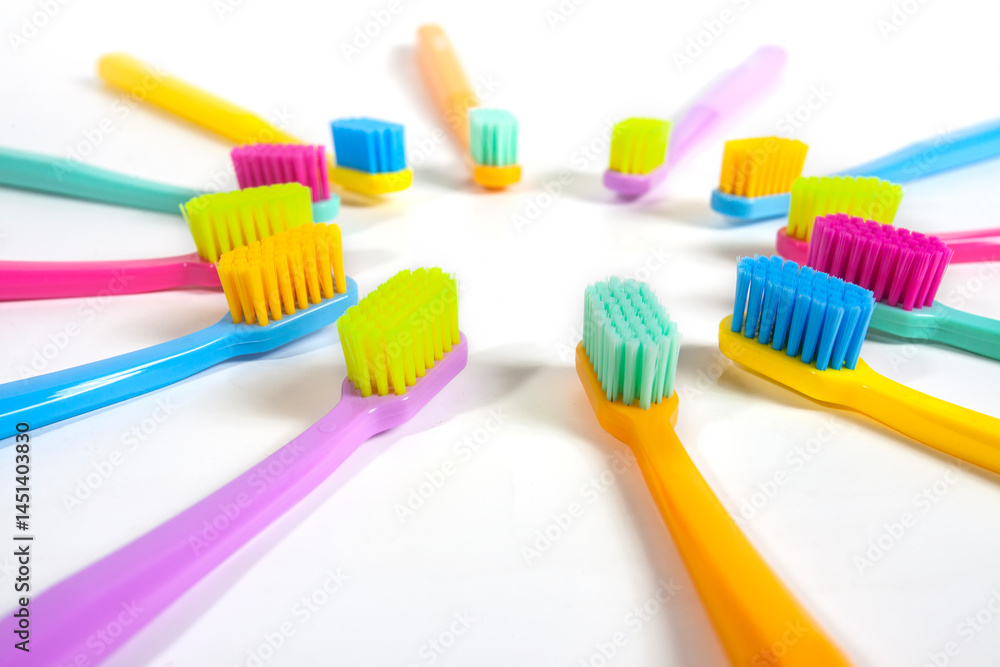 A set of multicolored toothbrushes isolated on white background. Design concept for dental and oral health theme.
