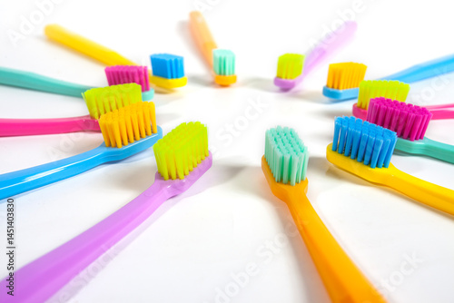 Obraz na płótnie A set of multicolored toothbrushes isolated on white background. Design concept for dental and oral health theme. w salonie