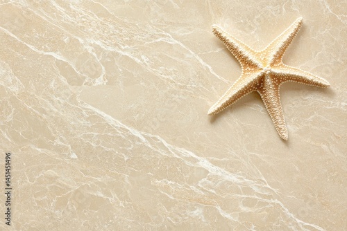 Beige marble surface with starfish.  Top view, natural light