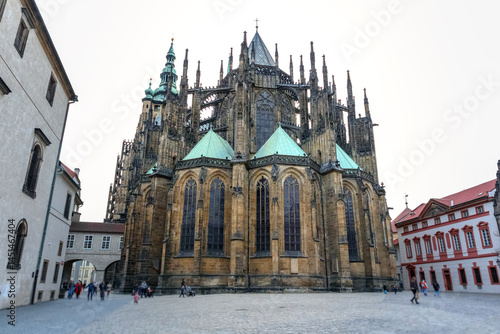 Photography a majestic Gothic cathedral with tall towers, intricate architectural elements and green roofs over the side chapels