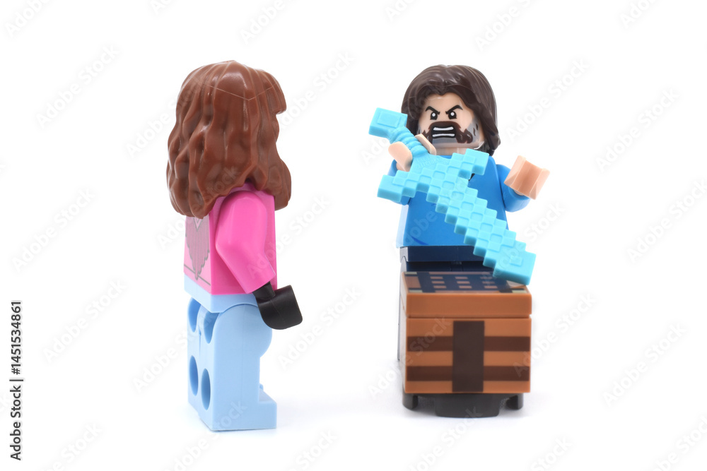 Fototapeta premium Lego minifigures of Garrett and Steve main character from video game Minecraft and movie are doing with weapons or swords. Editorial illustrative image of popular plastic toys.