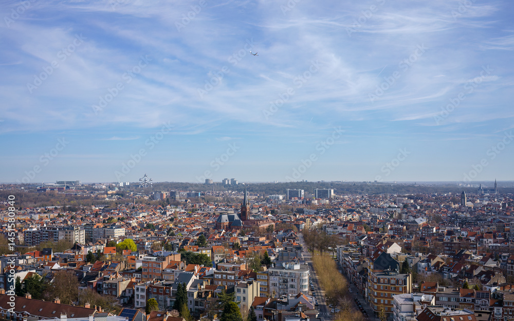 Naklejka premium Springtime view of the Brussels skyline with airplane in the sky.