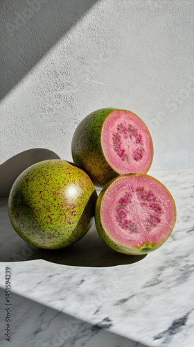 Obraz na płótnie Pink guava halves, whole fruit, marble w salonie