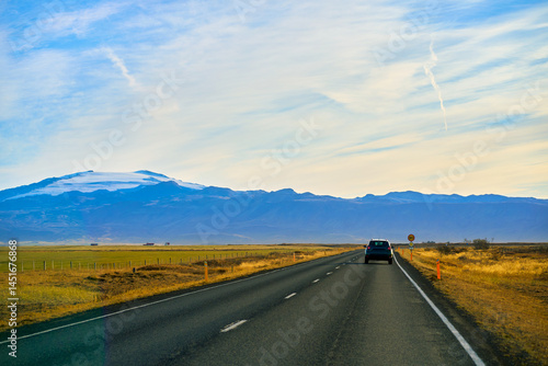 Roadtrip in iceland on ring road plan with countryside view field and mountain background.